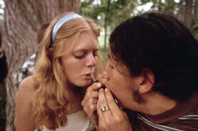 A young man and woman smoke pot during an outing near Leakey, Texas, May 1973. (Photo by Marc St. Gil/NARA via The Atlantic)