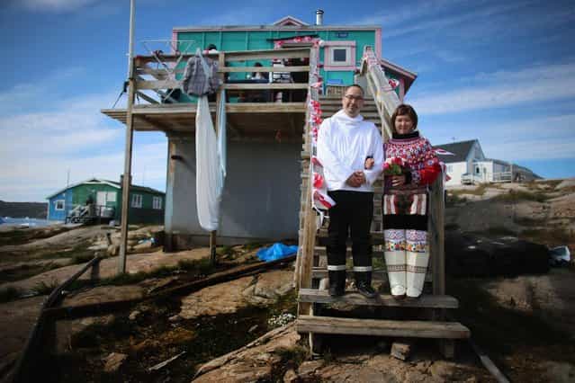 On the day of their wedding, Ottilie Olsen and Adam Olsen (left) pose for a picture in Qeqertaq, Greenland, on July 20, 2013. (Photo by Joe Raedle/Getty Images via The Atlantic)
