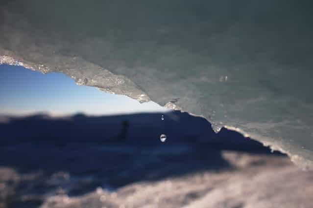 Part of the glacial ice sheet that covers about 80 percent of the country is seen on July 17, 2013 on the Glacial Ice Sheet, Greenland. (Photo by Joe Raedle/Getty Images via The Atlantic)