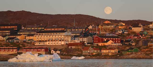 The village of Ilulissat, near icebergs from Jakobshavn Glacier, on July 24, 2013. (Photo by Joe Raedle/Getty Images via The Atlantic)