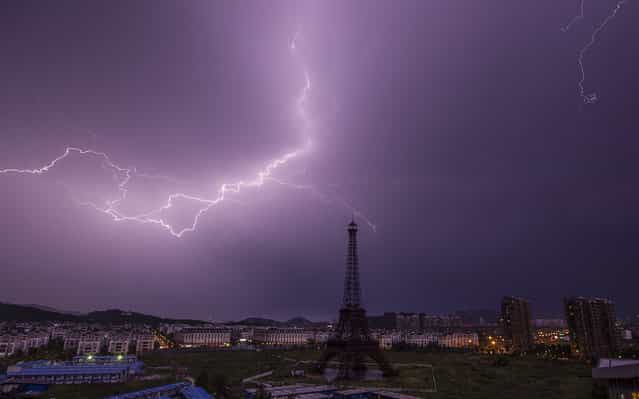 A lightning bolt streaks across the sky above a replica of the Eiffel Tower at the Tianducheng development in Hangzhou, Zhejiang Province August 1, 2013. (Photo by Aly Song/Reuters)