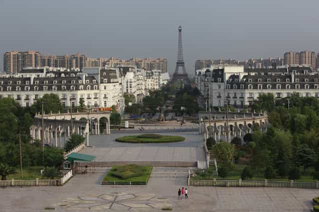 A view of the Tianducheng development in Hangzhou, Zhejiang Province August 1, 2013. Tianducheng, developed by Zhejiang Guangsha Co. Ltd., started constructing in 2007 and was known as a knockoff of Paris with a scaled-replica of the Eiffel Tower, standing 108 metres, and Parisian houses. Although designed to accommodate at least ten thousand people, Tianducheng remains sparsely populated and is now considered as a [ghost town], according to local media. (Photo by Aly Song/Reuters)