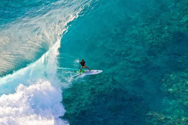 Photographer: Ben Thouard. Athlete: Manu Bouvet. Location: Tuamotus, French Polynesia. (Photo by Ben Thouard/Red Bull Illume via The Atlantic)