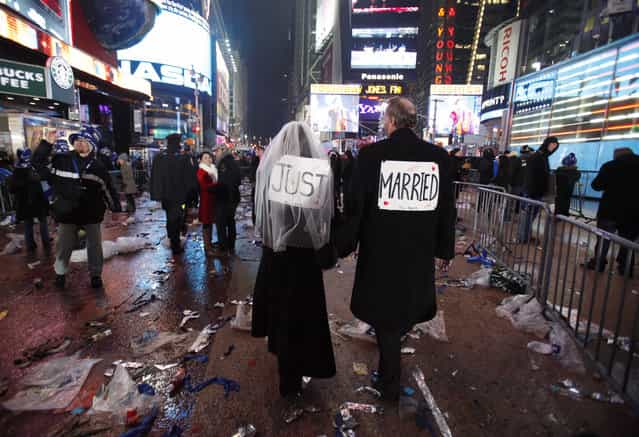 Melessa and Rick Clark leave the New Year celebration after exchanging vows in Times Square, New York January 1, 2010. (Photo by Jessica Rinaldi/Reuters)