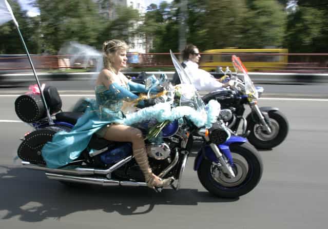 Yevgeni Okayevich (R) and his bride Galina Grann ride their motorbikes during their wedding in central Kiev July 5, 2008. (Photo by Konstantin Chernichkin/Reuters)