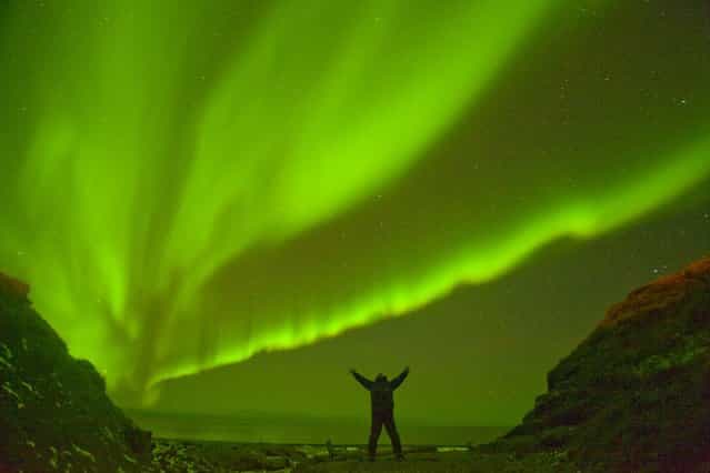 Northern lights (Aurora borealis) glow brightly over the 1002 coastal area of the Arctic National Wildlife Refuge in North Slope, Alaska. (Photo by Steven Kazlowski/Barcroft Media)