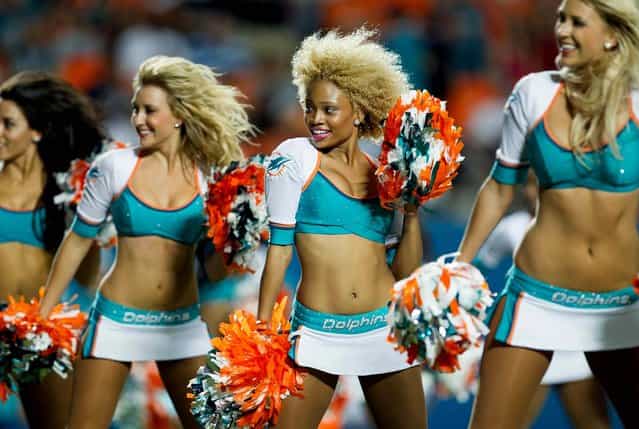 The Miami Dolphins cheerleaders perform during a preseason game against Tampa Bay at Sun Life Stadium in Miami Gardens. (Photo by Allen Eyestone/The Palm Beach Post)