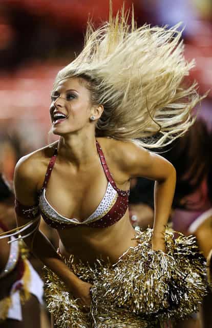 A Washington Redskins cheerleader preforms during a preseason game between the Redskins and Pittsburgh Steelers at FedExField in Landover, Md. (Photo by Rob Carr/Getty Images)