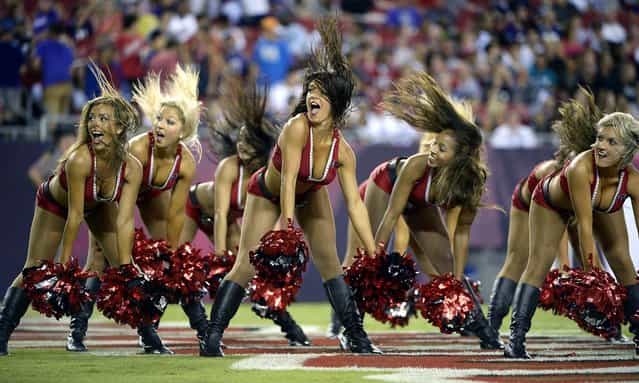 Tampa Bay Buccaneers cheerleaders perform during a preseason game against the Baltimore Ravens in Tampa. (Photo by Phelan M. Ebenhack/Associated Press)
