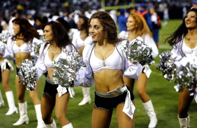 Oakland Raiders cheerleaders perform during a preseason game against the Dallas Cowboys in Oakland. (Photo by Marcio Jose Sanchez/Associated Press)