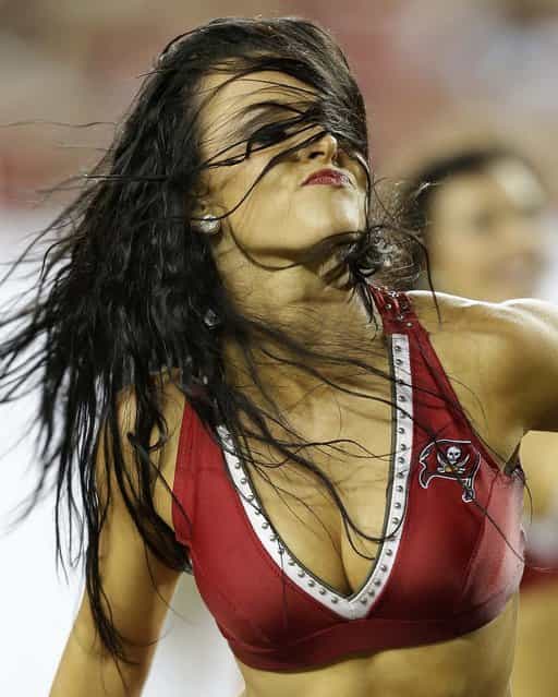 A Tampa Bay Buccaneers cheerleader performs during a preseason game against the Baltimore Ravens in Tampa. (Photo by Chris O'Meara)/Associated Press)