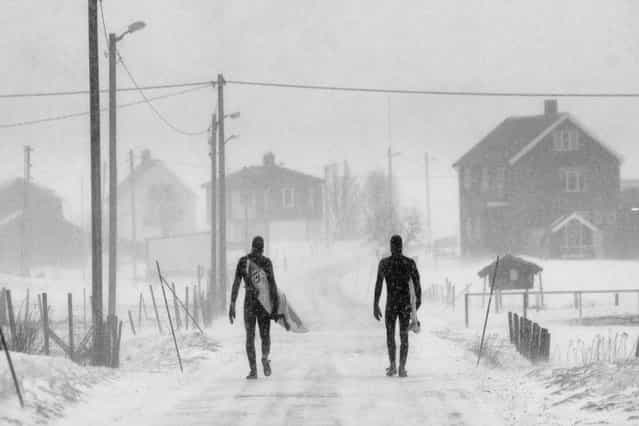 A shot of two surfers making their way home in the snow was captured by photographer Chris Burkhard to take first place in the [Spirit] category. (Photo by Chris Burkhard/Red Bull)