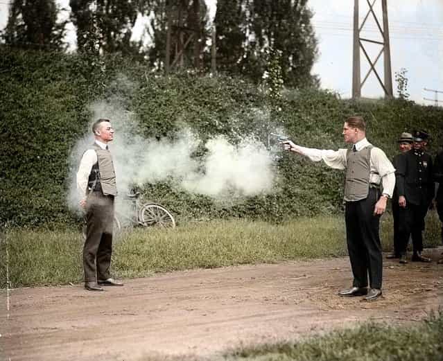 W. H. Murphy and his associate demonstrating their bulletproof vest on October 13, 1923. Colorized by zuzahin on Reddit. (Photo by National Photo Company)