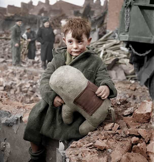 Abandoned boy holding a stuffed toy animal. London, 1945. Colorized by HansLucifer. (Photo by Toni Frissell)