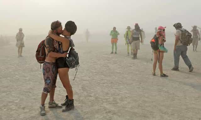 A couple kisses at Burning Man. (Photo by Andy Barron/The Reno Gazette-Journal)