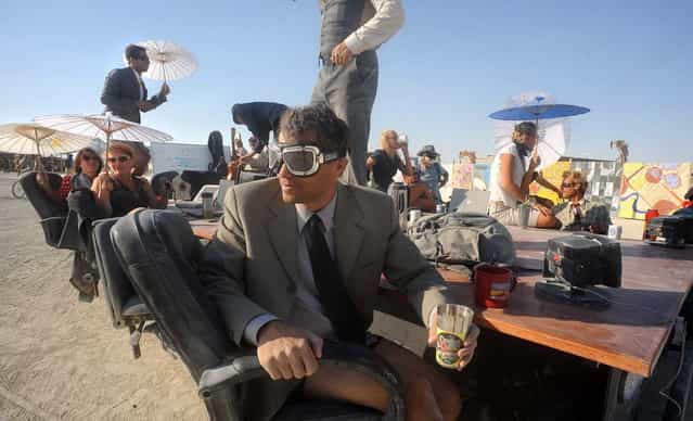 A [Mobile Board Room] moves along the playa at the Burning Man festival in Gerlach, Nev. on Thursday, Aug. 29, 2013. Once a year, tens of thousands of participants gather in Nevada's Black Rock Desert for the counterculture event. (Photo by Andy Barron/AP Photo/Reno Gazette-Journal)
