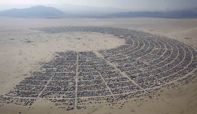 An aerial view of the Burning Man 2013 arts and music festival is seen in the Black Rock Desert of Nevada, August 29, 2013. The federal government issued a permit for 68,000 people from all over the world to gather at the sold out festival, which is celebrating its 27th year, to spend a week in the remote desert cut off from much of the outside world to experience art, music and the unique community that develops. (Photo by Jim Urquhart/Reuters)