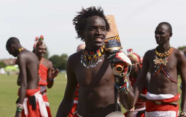 Lesikito Christopher Memusi Ole Ngais (C) of the Maasai Cricket Warriors team from Kenya smiles after his team won a match against English team [The Shed] during [The Last Man Stands] cricket tournament at Dulwich sports ground in South London September 1, 2013. (Photo by Philip Brown/Reuters)