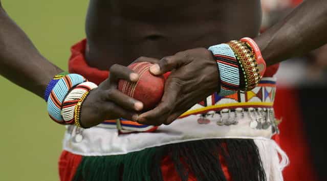 A member of the Maasai cricket warrior team from Kenya holds a ball before a cricket match against English team [The Shed] during the Last Man Stands cricket tournament at Dulwich sports ground in south London September 1, 2013. (Photo by Philip Brown/Reuters)