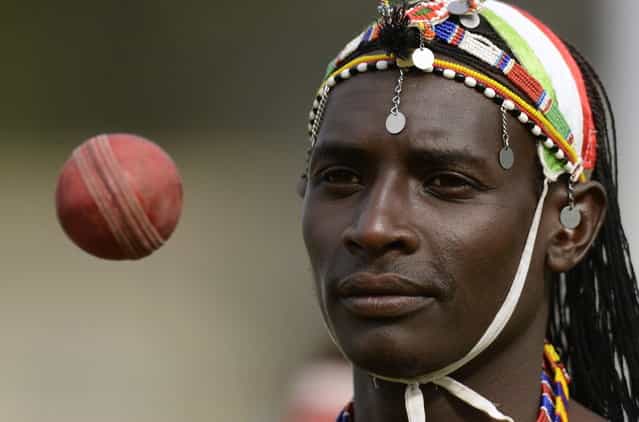 Sonyanga Ole Ngais of the Maasai cricket warrior team from Kenya throws a ball before a cricket match against English team [The Shed] during the Last Man Stands cricket tournament at Dulwich sports ground in south London September 1, 2013. (Photo by Philip Brown/Reuters)
