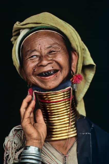 A rarity in Myanmar, a woman models her brass neck rings, Loikaw, Burma (Myanmar), 1994. (Photo by Steve McCurry)