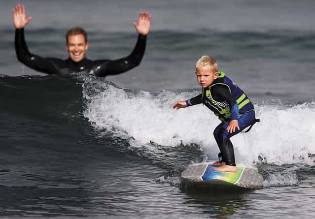 Triston surfs a wave as his father, Todd, watches in Morro Bay. [Hes the most coordinated 3-year-old I've ever seen], says the 35-year-old captain/paramedic with the Morro Bay Fire Department. (Photo by Joe Johnston/The Tribune of San Luis Obispo)
