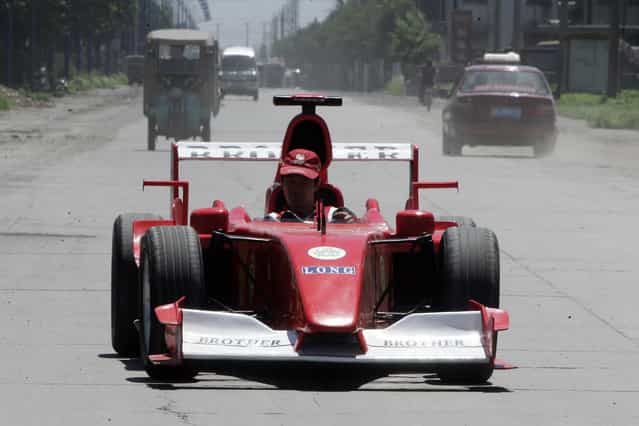 Zhao Xiuguo drives a homemade model of Formula One car in Tangshan, Hebei Province, some 180km (113 miles) east of Beijing July 21, 2006. Zhao Xiuguo and his brother Zhao Xiushun built the car from scrap metal and said that they wanted to design and build the first Formula One racecar in China. (Photo by Claro Cortes IV/Reuters)