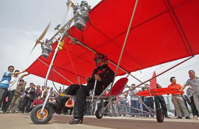 Farmer Shu Mansheng prepares to take off with his homemade ultralight aircraft in Wuhan, Hubei province May 10, 2010. The 4.5-meter-long (15ft) ultralight, powered by two motor engines, took Shu eight months to build and cost him 5,000 yuan (733 USD), local media reported. (Photo by Reuters/China Daily)