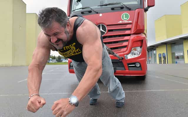 Heinz Ollesch, for several times bearer of the title [Strongest man of Germany], pulls a seven-tons truck on September 9, 2013 in Chemnitz, eastern Germany, to promote the German Truck Pulling Championships. The competition is scheduled to take place during the Commcar fair for commercial cars from October 12 to 13, 2013 in Chemnitz. (Photo by Hendrik Schmidt/AFP Photo/DPA)