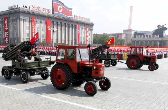 Tractors pull artillery through Kim Il Sung Square during a military parade to mark the 65th anniversary of the country's founding in Pyongyang, North Korea, Monday, September 9, 2013. (Photo by Kim Kwang Hyon/AP Photo)