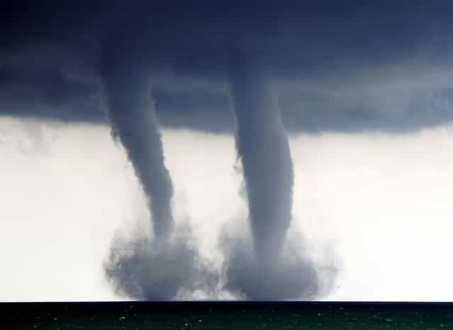 A pair of water spouts form on Lake Michigan southeast of Kenosha, Wisconsin, on September 12, 2013. The National Weather Service in Sullivan said the water spouts occurred about four miles southeast from Kenosha. (Photo by Kevin Poirier/The Kenosha News)