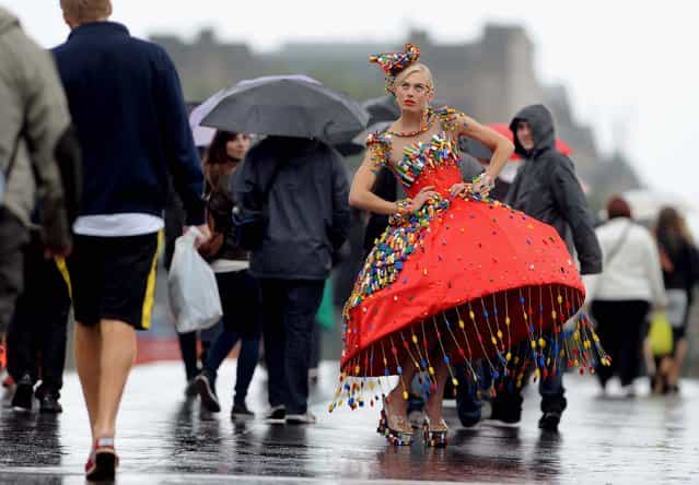 To get in to the spirit of London Fashion Week, model Aspen Glen-Cross poses in a dress adorned with around 5000 LEGO bricks designed by Central Saint Martins College of Art and Design student, Anne-Sophie Cochevelou, in central London, September 12, 2013. (Photo by Anthony Devlin/PA Wire)