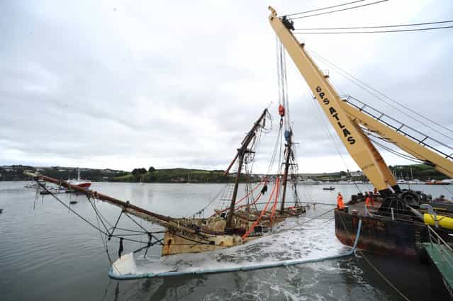 The wreck of the sail training ship the Astrid is uprighted at Lobster Quay in Kinsale, co Cork, on September 10, 2013. (Photo by Dan Linehan)