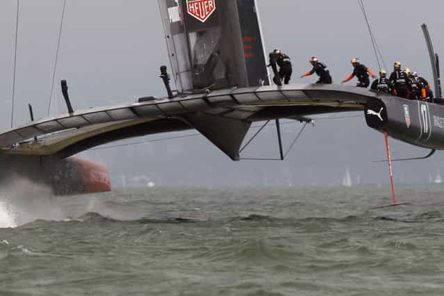 Oracle Team USA rounding the first mark against Emirates Team New Zealand during Race 4 of the 34th America's Cup yacht sailing race in San Francisco, on September 11, 2013. (Photo by Reuters)