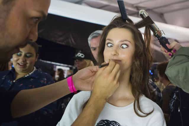A model makes a face while being made up before the Herve Leger by Max Azria Spring/Summer 2014 collection show during New York Fashion Week, on September 8, 2013. (Photo by Eric Thayer/Reuters)