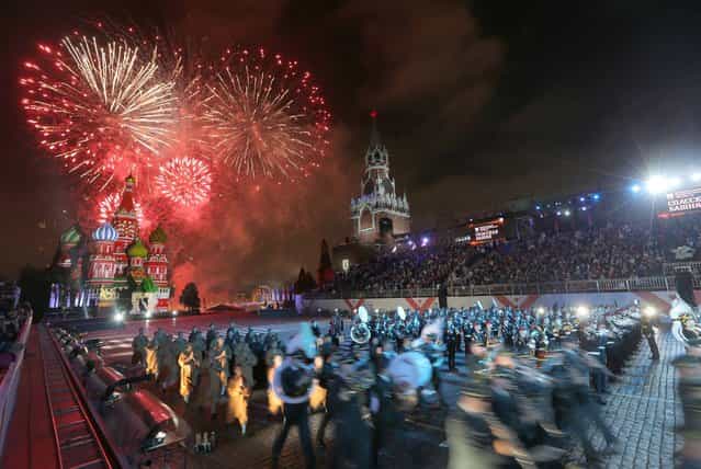 Fireworks explode in the sky over St. Basil Cathedral during the [Spasskaya Tower] International Military Orchestra Music Festival at the Red Square in Moscow, Russia, late Saturday, September 7, 2013. (Photo by Sergei Grits/AP Photo)