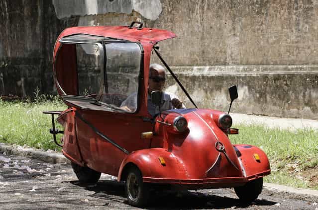 Jose Alberto Sarmiento sits in his 1957 Messerschmitt KR200 microcar on a street in Havana May 20, 2010. The bubble car has been in the possession of the lamp maker's family since before the Cuban Revolution. The three-wheeler was produced by the German aircraft manufacturer Messerschmitt from 1955 to 1964. There are only 36 of the cars remaining in Cuba. (Photo by Desmond Boylan/Reuters)