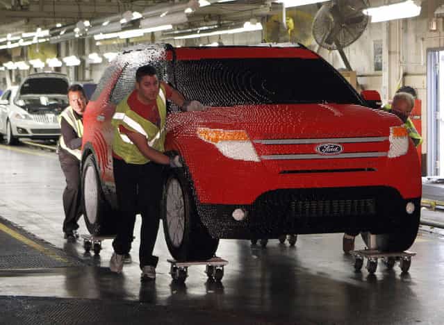 Workers from Ford's Chicago Assembly Plant push a full-size Legoland edition Ford Explorer, made with more than 380,000 Lego blocks, at Ford's Chicago Assembly Plant in Chicago, Illinois September 26, 2011. The candy-apple red Explorer will be on display at the soon-to-open Legoland Florida theme park near Orlando. (Photo by Frank Polich/Reuters)