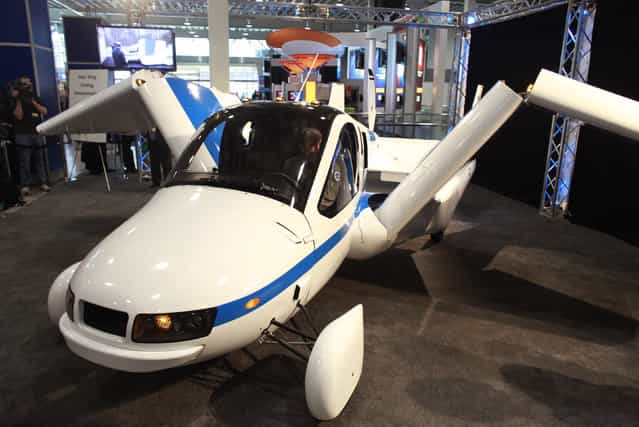 The Terrafugia Transition, a flying car, unfolds its wings at the 2012 New York International Auto Show at the Javits Center in New York, April 5, 2012. (Photo by Allison Joyce/Reuters)