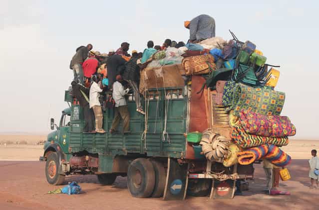 Truck in Mopti, Mali. The difference between supercharged and overloaded might often be close, but we could learn a lot of the endless African creativity in loading cargo on automobiles, bikes or donkey charts. (Photo and caption by Ferdinand Reus)