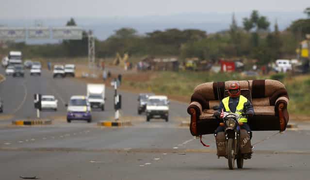 A man carries a sofa on his motorcycle on a highway near Kenya's capital Nairobi March 10, 2013. (Photo by Marko Djurica/Reuters)