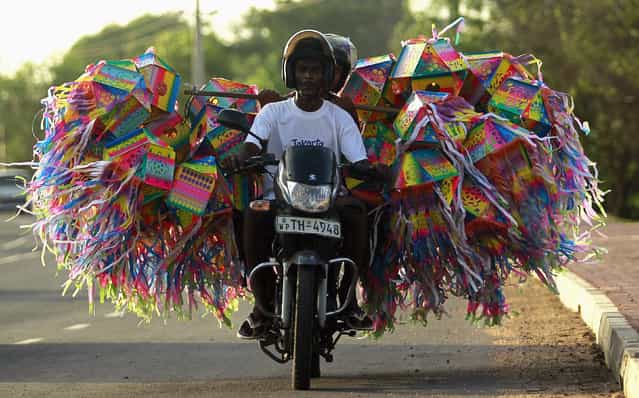 A man transports lanterns for decorations on his motorbike ahead of Vesak Day celebrations in Colombo May 4, 2012. (Photo by Dinuka Liyanawatte/Reuters)
