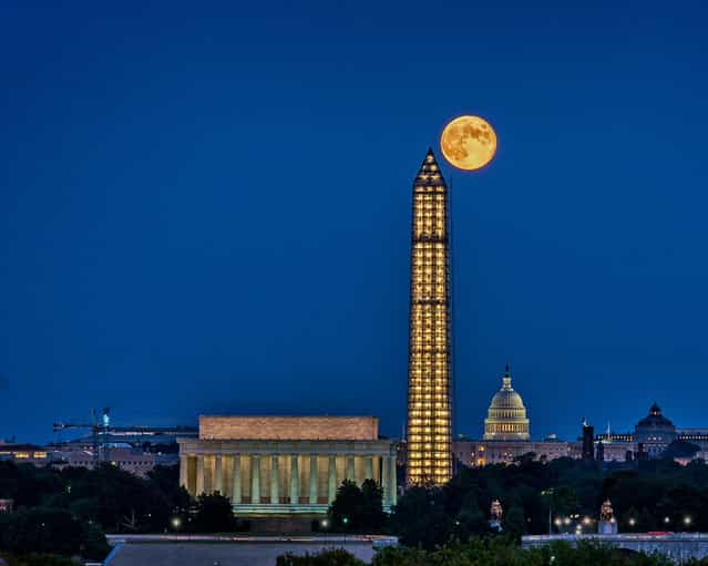 Photographer Tom Finzel took this photo of the harvest moon abutting the Washington Monument over D.C. on September 19, 2013. (Photo by Tom Finzel)