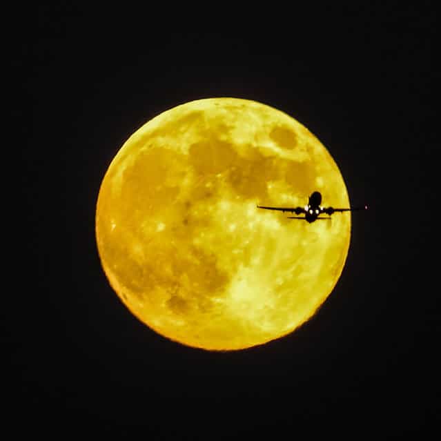Photographer Stephen Rahn took this photo of the moon with an airliner in front of it on September 18, 2013. He writes: [I was at my parents' house this evening when my dad and I saw the Moon coming up. I set up the tripod and … he noticed all these planes flying near the Moon. He helped spot for me, and I managed to get this]. (Photo by Stephen Rahn)