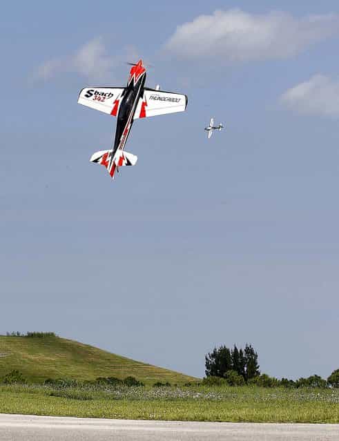 A 1/4 scale Decathlon remote control gas powered plane does a stall maneuver while another planes flies in the background. (Photo by Bill Ingram/The Palm Beach Post)