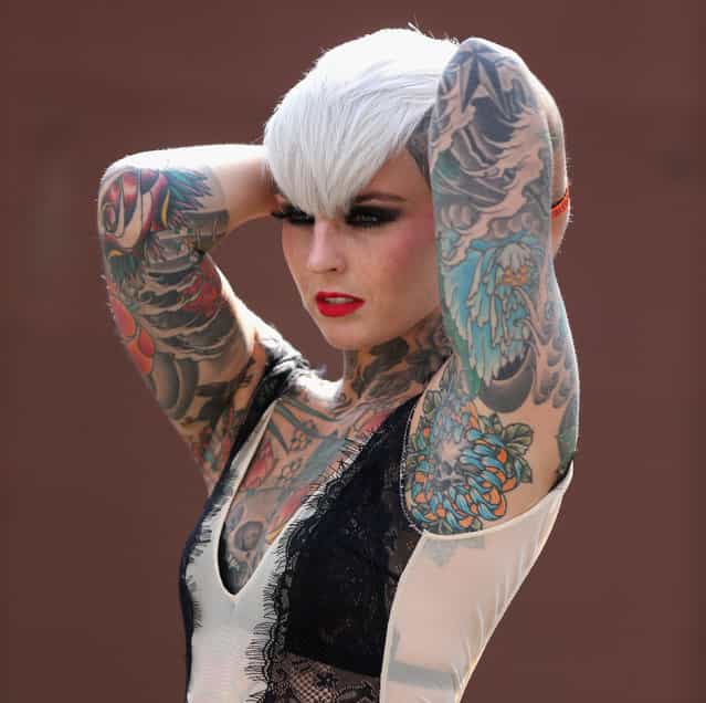 A tattooed model poses for photographers at the London Tattoo Convention in Tobacco Dock on September 27, 2013 in London, England. (Photo by Oli Scarff/Getty Images)