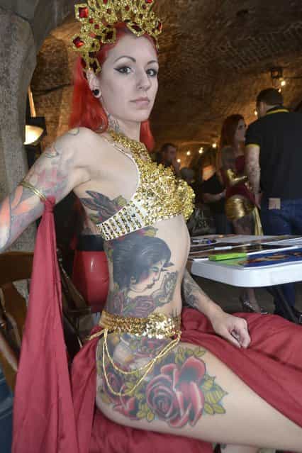 Cervena Fox, a fetish dancer who has tattoos running up the side of her body, pictured here at the 9th International London Tattoo Convention. (Photo by Everton Green/Demotix/Corbis)