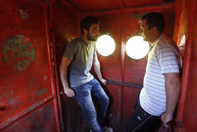 Commuters chat inside a cable car in the town of Chiatura, some 220 km (136 miles) northwest of Tbilisi, September 12, 2013. (Photo by David Mdzinarishvili/Reuters)