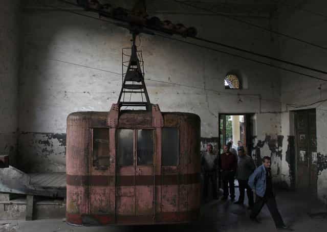 Commuters get out of a 60-year-old cable car in the town of Chiatura, some 220 km (136 miles) northwest of Tbilisi, September 12, 2013. (Photo by David Mdzinarishvili/Reuters)