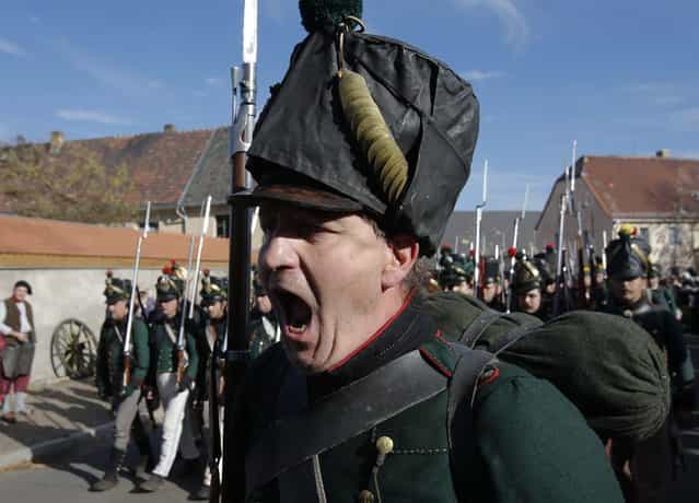 A performer wearing 19th century Saxonian military uniform shouts commands during a practice for the reenactment of the Battle of the Nations in the village of Liebertwolkwitz near Leipzig October 19, 2013. The east German city of Leipzig is commemorating the 200th anniversary of the largest battle of the Napoleonic Wars on Sunday by reenacting the Battle of Nations, with 6,000 military-historic association enthusiasts from all over Europe. Some 185,000 French troops and 320,000 allied troops from Austria, Prussia, Russia and Sweden, entered into the decisive battle just outside Leipzig on October 16, 1813. (Photo by Fabrizio Bensch/Reuters)